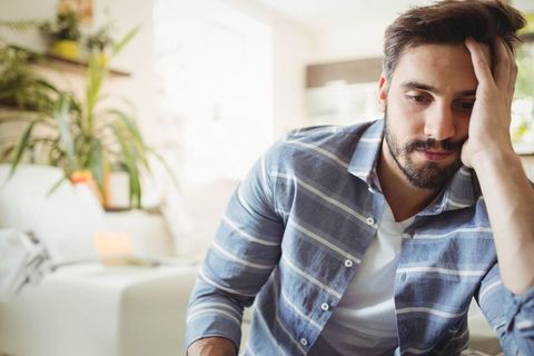 Man Resting in Comfortable Living Room Surrounded by Plants