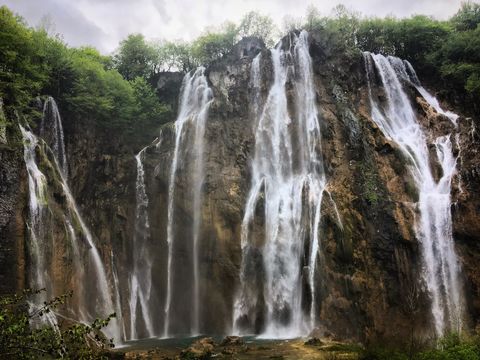 Majestic Waterfall Cascading Over Rocky Cliffs