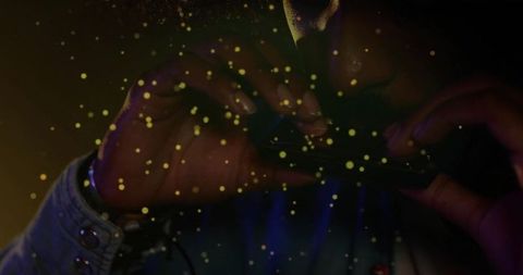 Musician focused on playing harmonica with dark stage ambiance