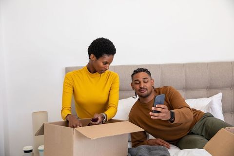 Couple Engaging in Bedroom Decluttering Session