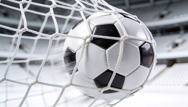 Scoring soccer ball hitting goal net closeup showing motion blur and stadium impact