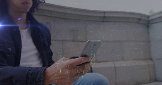 This image shows a young person casually sitting outdoors while using a smartphone. The photo includes digital overlay effects that imply connections to technology, communication, or cybersecurity themes. Perfect for articles, advertisements, or blog posts featuring modern digital lifestyles, app promotions, or urban living.