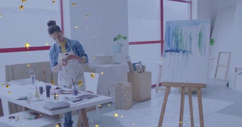 Creative female artist evaluating artwork in studio