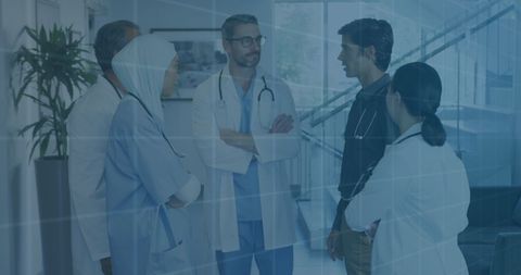 Diverse Doctors Engaging in Medical Consultation with Data Overlay - Download Free Stock Images Pikwizard.com