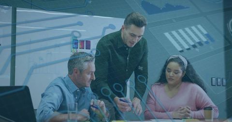 Team collaborating over data with digital analytics overlay for business strategy planning