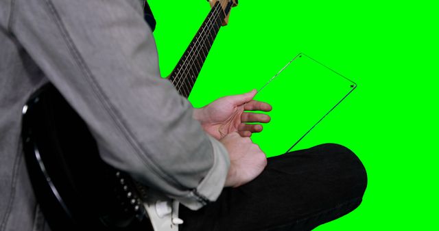 Musician Holding Transparent Tablet with Green Screen Background - Download Free Stock Images Pikwizard.com