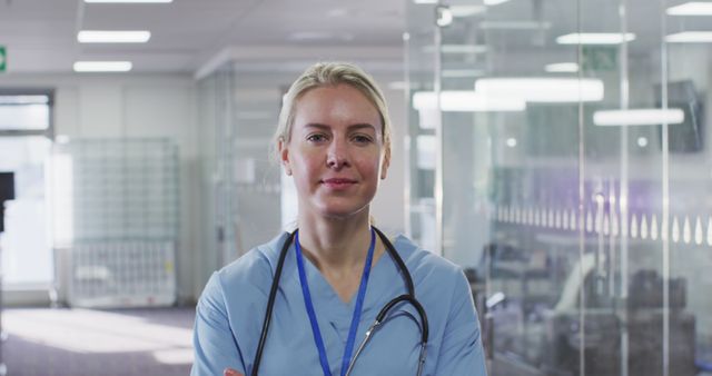 Confident Female Medical Professional in Hospital Corridor - Download Free Stock Images Pikwizard.com