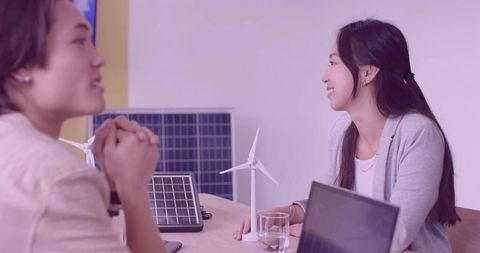 Team discussing renewable energy models in office meeting