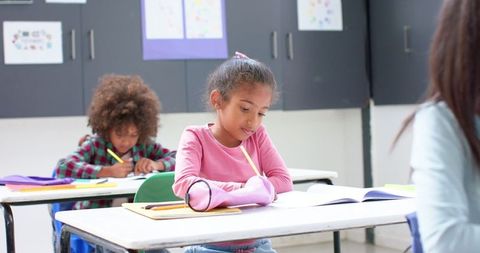 Focused students writing in classroom for effective learning
