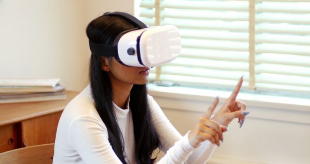 Woman using virtual reality headset in living room at home