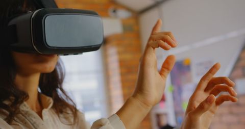 Woman Engaging with VR Tech in Modern Office - Download Free Stock Images Pikwizard.com