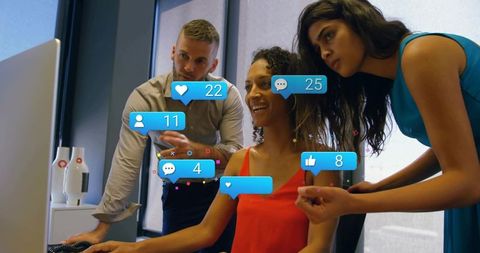 Marketing team collaborating on social media dashboard with floating engagement icons