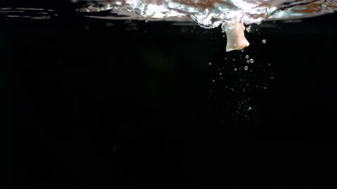 Close-Up Mushroom Dropping Into Water with Splash Effect