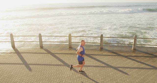 Man Running on Beachside Path at Sunrise - Download Free Stock Images Pikwizard.com