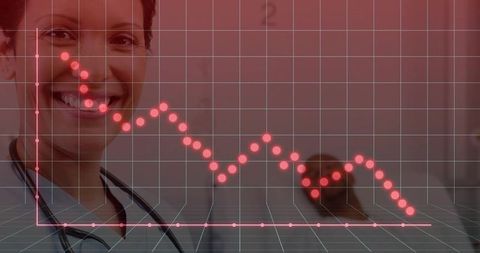 Smiling clinician presenting declining health data on red grid overlay for medical analytics