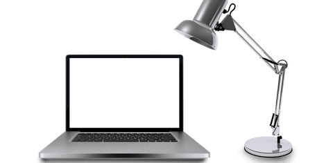 Image shows a gray desk lamp angled towards an open laptop with a transparent screen, displaying a minimalist style ideal for office, technology highlights, and modern workspace themes. Can be used in tech setup blogs, design catalogs, and marketing materials emphasizing workspace efficiency and modern desk aesthetics.