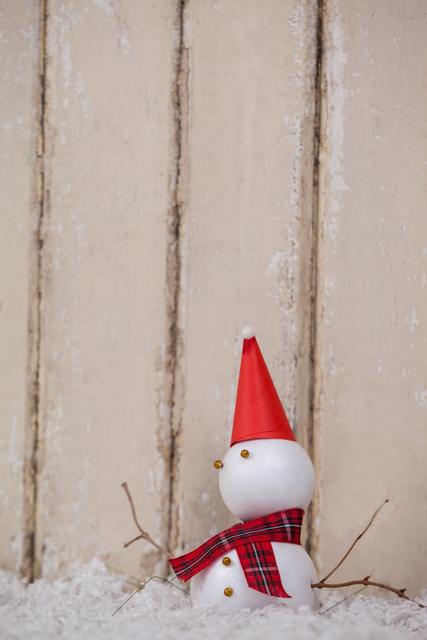 Cute Snowman with Red Hat and Scarf in Fake Snow - Download Free Stock Photos Pikwizard.com