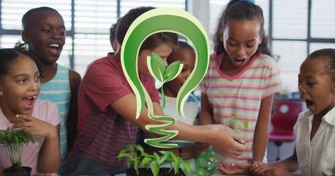 Diverse schoolchildren enthusiastically planting greenery indoors