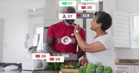Couple preparing green smoothie while sharing snack amid social media alerts overlay