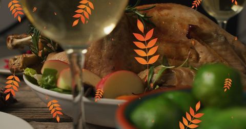 Festive Thanksgiving Dinner with Autumn Leaves Overlay