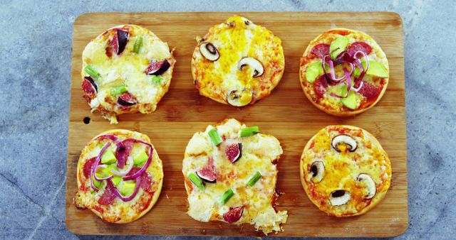 Assorted Mini Pizzas with Various Toppings on Wooden Board - Download Free Stock Images Pikwizard.com