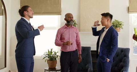 Men Celebrating Friendship at Wedding Reception in Stylish Formalwear