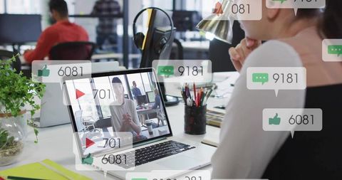 Professional Woman Viewing Laptop with Social Media Notifications at Office