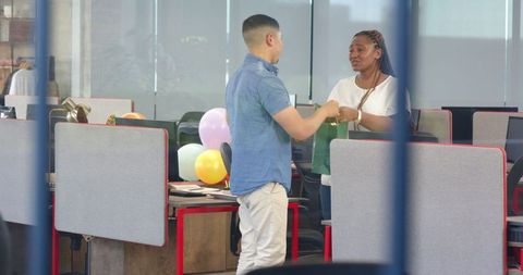 Joyful Office Birthday Celebration with Colleagues Exchanging Gifts