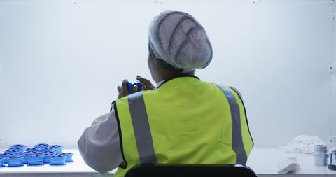 Female Worker Inspecting Plastic Parts in Factory