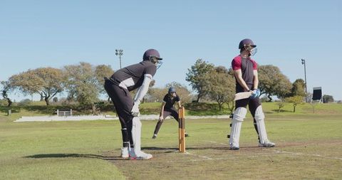 Cricketers on Field Ready for Next Delivery