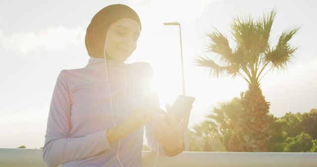 Muslim Woman Wearing Hijab and Using Smartphone Outdoors - Download Free Stock Images Pikwizard.com