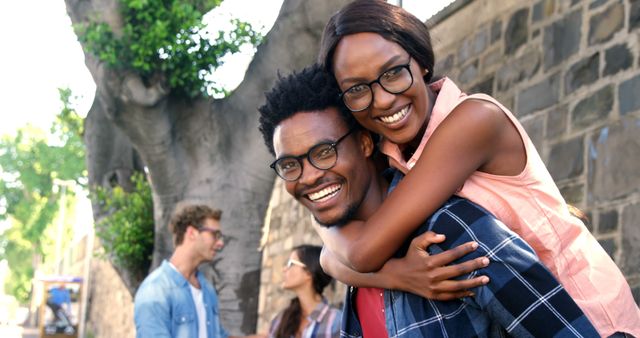 Smiling Couple in Casual Wear Piggyback Outdoors - Download Free Stock Images Pikwizard.com