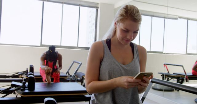 Women Exercising in Pilates Studio, Checking Mobile Phone - Download Free Stock Images Pikwizard.com