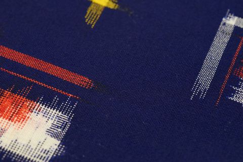Featuring abstract pixel brush strokes in red white and yellow on navy woven fabric texture