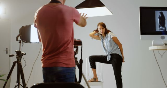 A young Caucasian woman poses confidently during a photo shoot, with copy space - Download Free Stock Photos Pikwizard.com