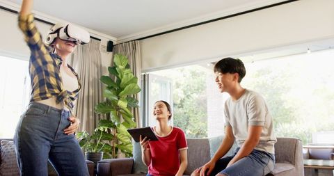 Joyful Friends Enjoying Virtual Reality Together at Home