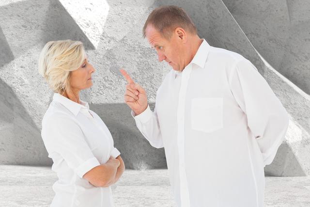 Digital composite of Senior man pointing at woman while arguing against gray background