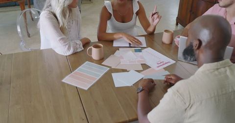Diverse team collaborating on wedding planning color palette