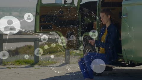 Woman Using Tablet with Digital Network Overlay Near Van