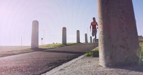 woman jogging on sunny day high contrast perspective - Download Free Stock Images Pikwizard.com