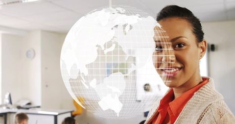 Female teacher presenting holographic globe in classroom with digital learning technology