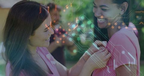 Women Volunteering in Garden Wearing Pink Shirts with Ribbon Symbol