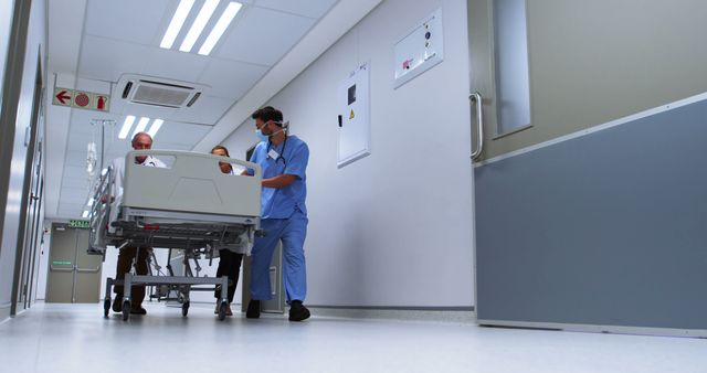 Hospital Staff Transporting Patient on Gurney in Medical Facility - Download Free Stock Images Pikwizard.com