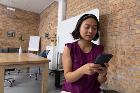 Businesswoman Engaging with Tablet in Modern Industrial Office