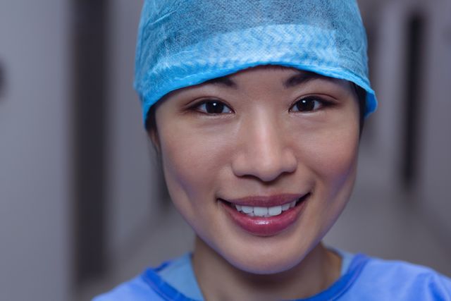 Close-up of happy female surgeon looking at camera at hospital