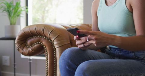 Caucasian Woman Relaxing with Smartphone in Stylish Home Setting