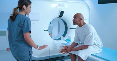 African american patient consulting with radiology technician before ct scan in hospital