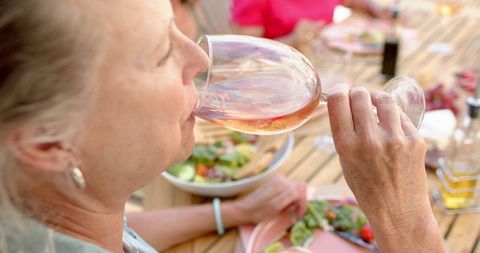 Senior Woman Savoring Wine at Casual Friends Gathering Outdoors - Download Free Stock Images Pikwizard.com