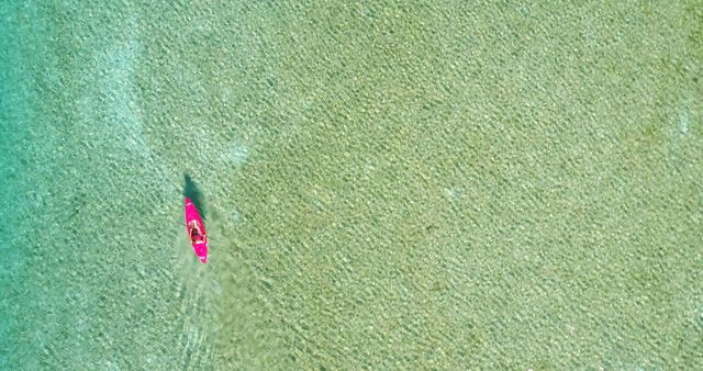 Aerial view of a person kayaking alone in clear, shallow waters, with copy space - Download Free Stock Photos Pikwizard.com