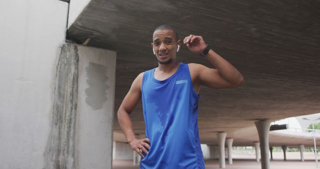 Athletic Man Resting Under Urban Bridge After Intense Jogging Session - Download Free Stock Images Pikwizard.com